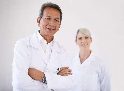 They make a great dentistry team. Portrait of a dentist and his assistant in Stock Photos