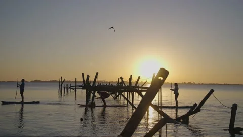 They paddle across the old pier Stock-Footage 164479652