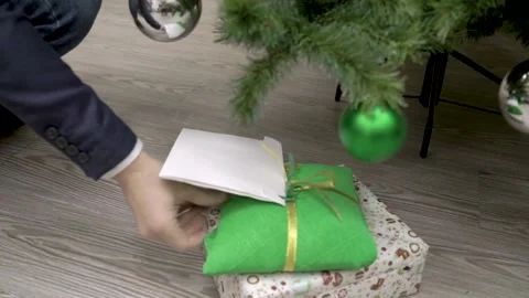 They put gifts under the tree. Stock Footage 147444438