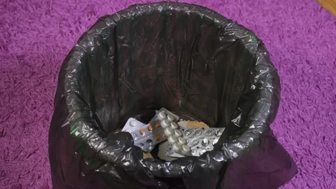 They throw a bunch of different pills into the trash, get rid of medications Stock Footage 265147893