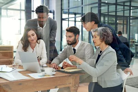 Theyre all on the same page. Cropped shot of a group of businesspeople meeting 写真素材