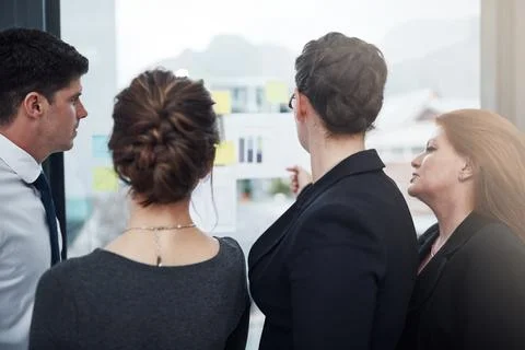 Theyre the best team of problem solvers. a group of businesspeople brainstorming Foto stock
