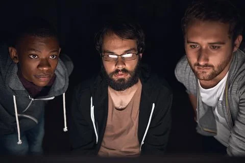 Theyre a top notch programming team. young computer programmers working late in Stock-Fotos