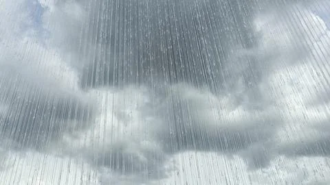 Thick and dark clouds with an artificial curtain of water covering them. Foto stock
