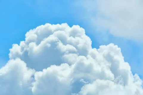 Thick and large white clouds in the blue sky Stock Photos