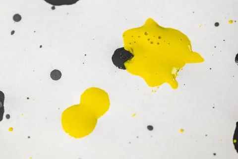 Thick and shiny splashes of black and yellow paint scattered. Stock Photos