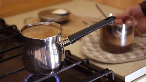 Thick, aromatic coffee brewed on the fire. the Barista is waiting for the Stock Footage 73707234
