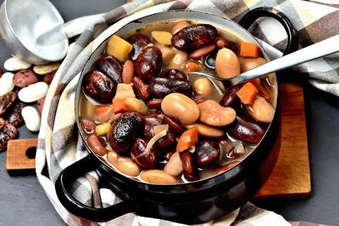 Thick bean soup with large beans in an old enamel pot Stock Photos