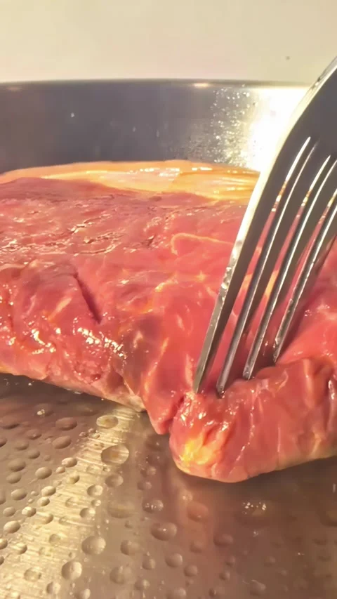 Thick Beef Steak Turned With Fork Showing Golden Brown Crust in Pan, Static Shot Vidéo 338173743