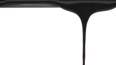 Thick black liquid is slowly dripping from the top of the frame. Isolated on Stock Footage 194158154