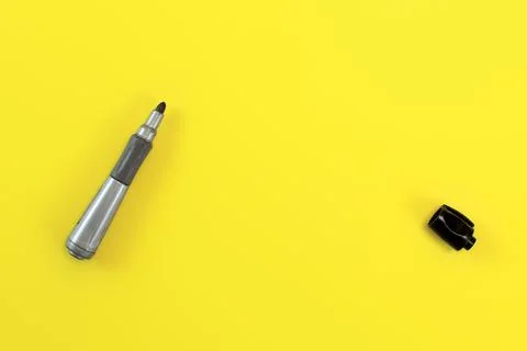 Thick black marker pen with opened cap on yellow board - space to write your  Stock Photos