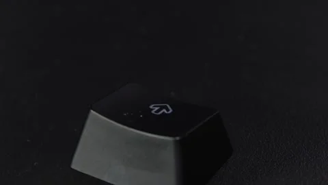 The thick black mechanical keyboard key black surface rotates 360 degrees Stock Footage 250976674