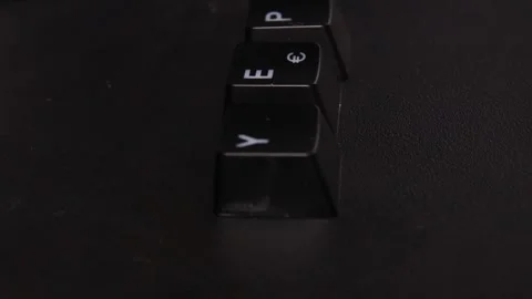 The thick black mechanical keyboard key black surface rotates 360 degrees Stock Footage 250978512
