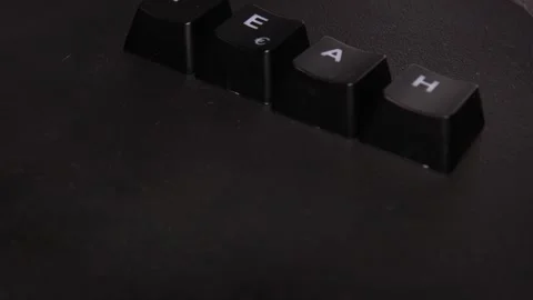 The thick black mechanical keyboard key black surface rotates 360 degrees Stock Footage 250979357