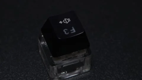 The thick black mechanical keyboard key connected to the blue switch on a black Stock Footage 253821870