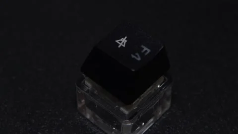 The thick black mechanical keyboard key connected to the blue switch on a black Stock Footage 253821945