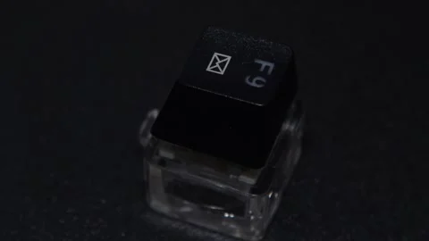 The thick black mechanical keyboard key connected to the blue switch on a black Stock Footage 253821947
