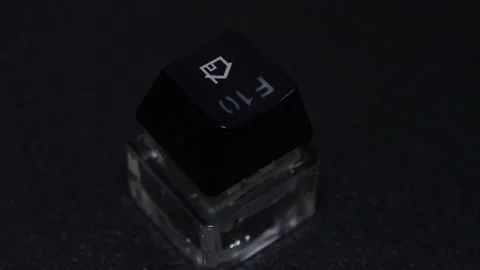The thick black mechanical keyboard key connected to the blue switch on a black Stock Footage 253821986