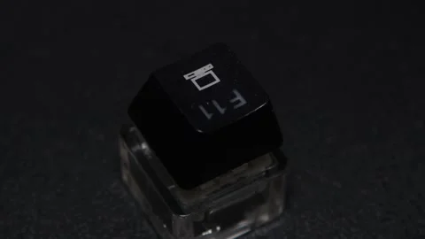 The thick black mechanical keyboard key connected to the blue switch on a black Stock Footage 253822040