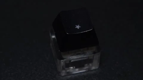 The thick black mechanical keyboard key connected to the blue switch on a black Stock Footage 253822135
