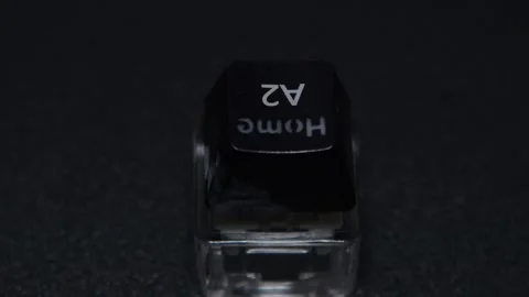 The thick black mechanical keyboard key connected to the blue switch on a black Stock Footage 253822318
