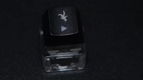 The thick black mechanical keyboard key connected to the blue switch on a black Stock Footage 253822490