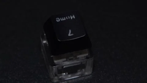 The thick black mechanical keyboard key connected to the blue switch on a black Stock Footage 253822651