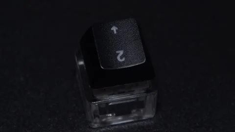 The thick black mechanical keyboard key connected to the blue switch on a black Stock Footage 253822841