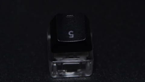 The thick black mechanical keyboard key connected to the blue switch on a black Stock Footage 253822852