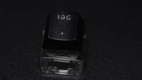 The thick black mechanical keyboard key connected to the blue switch on a black Stock Footage 253823043