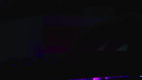 The thick black mechanical keyboard key connected to the blue switch on a black Stock Footage 253999573