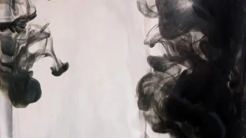 Thick black paint falls down into clear water against the background Stock Footage 291110821