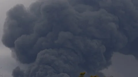 Thick black smoke covers the sky during the war between Ukraine and Russia Stock Footage 173744927