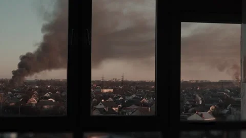 Thick black smoke rises into the sky from a burning after a rocket attack Video stock 327216030