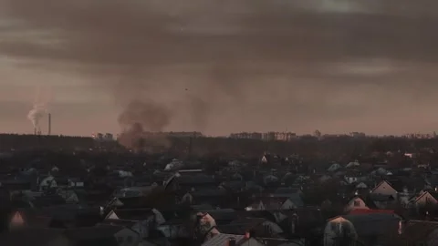 Thick black smoke rises into the sky from a burning after a rocket attack Stock Footage 327216048