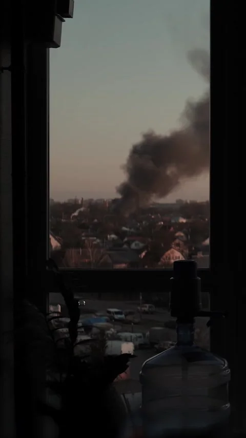 Thick black smoke rises into the sky from a burning after a rocket attack Stock Footage 327216090