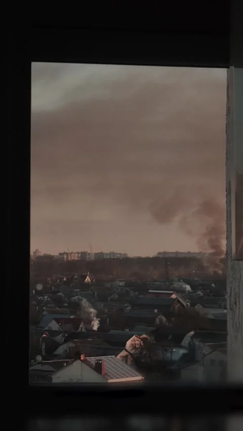 Thick black smoke rises into the sky from a burning after a rocket attack Stock Footage 327216137