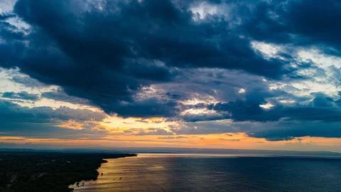 Thick blue clouds during sunset seen from Walakiri Beach Stock Photos