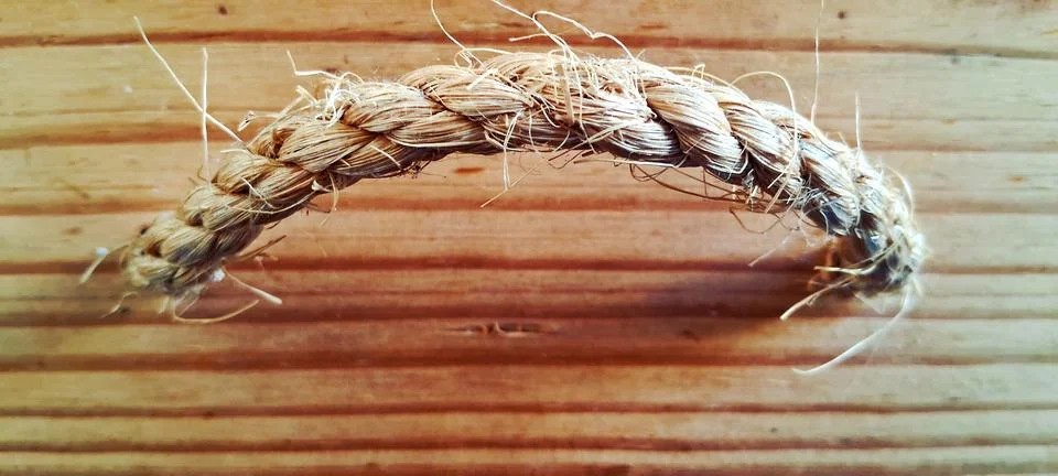 Thick braided rustic rope crafted from natural dried brown fibers Stock Photos