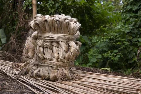A thick brown  bundle of raw jute has on the ground Stock Photos