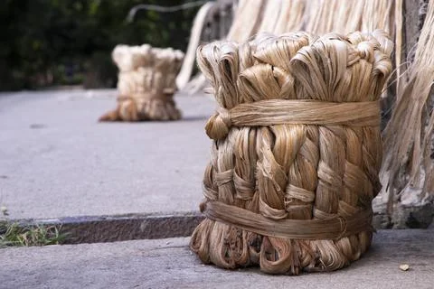 A thick brown  bundle of raw jute has on the ground Stock Photos