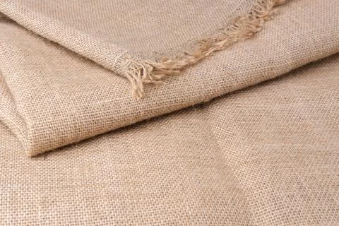 Thick burlap lies on the table in several layers. Stock Photos