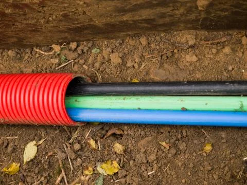 Thick cables in trench during construction Stock Photos