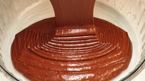 Thick Chocolate Batter Pouring Into Baking Dish Closeup Stock Photos
