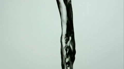 Thick clear viscous liquid pouring against light grey background Stock Footage 327578204