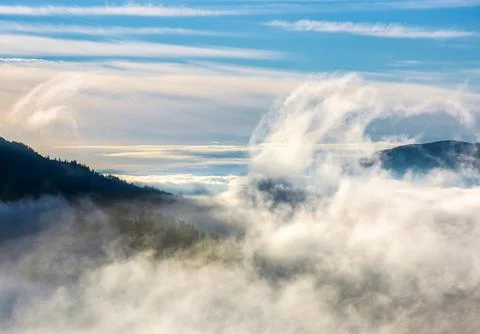 Thick cloud formation rising from the valley Stock Photos