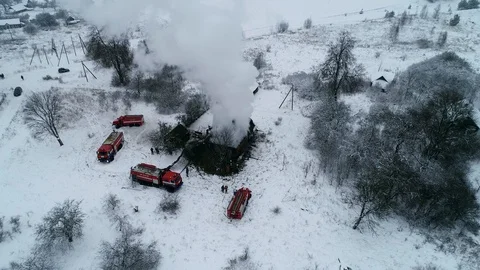 A thick cloud of smoke rises from the blazing fire of a house in the village Stock Footage 100316959
