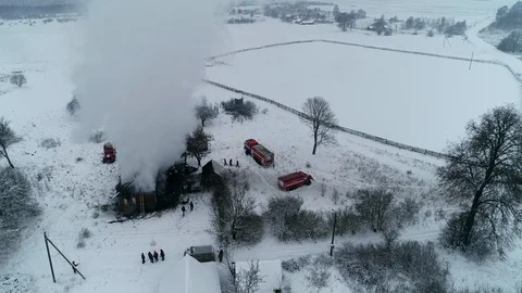 A thick cloud of smoke rises from the blazing fire of a house in the village Stock Footage 100348248