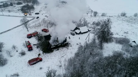 A thick cloud of smoke rises from the blazing fire of a house in the village Stock Footage 100348829