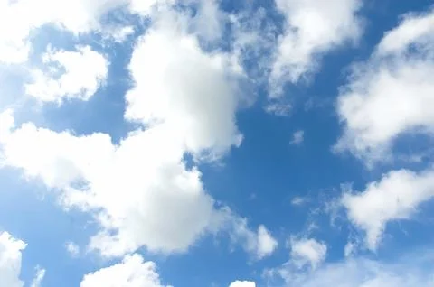 Thick clouds behind the hot sun. Beautiful white clouds in the bright blue .. Stock Photos